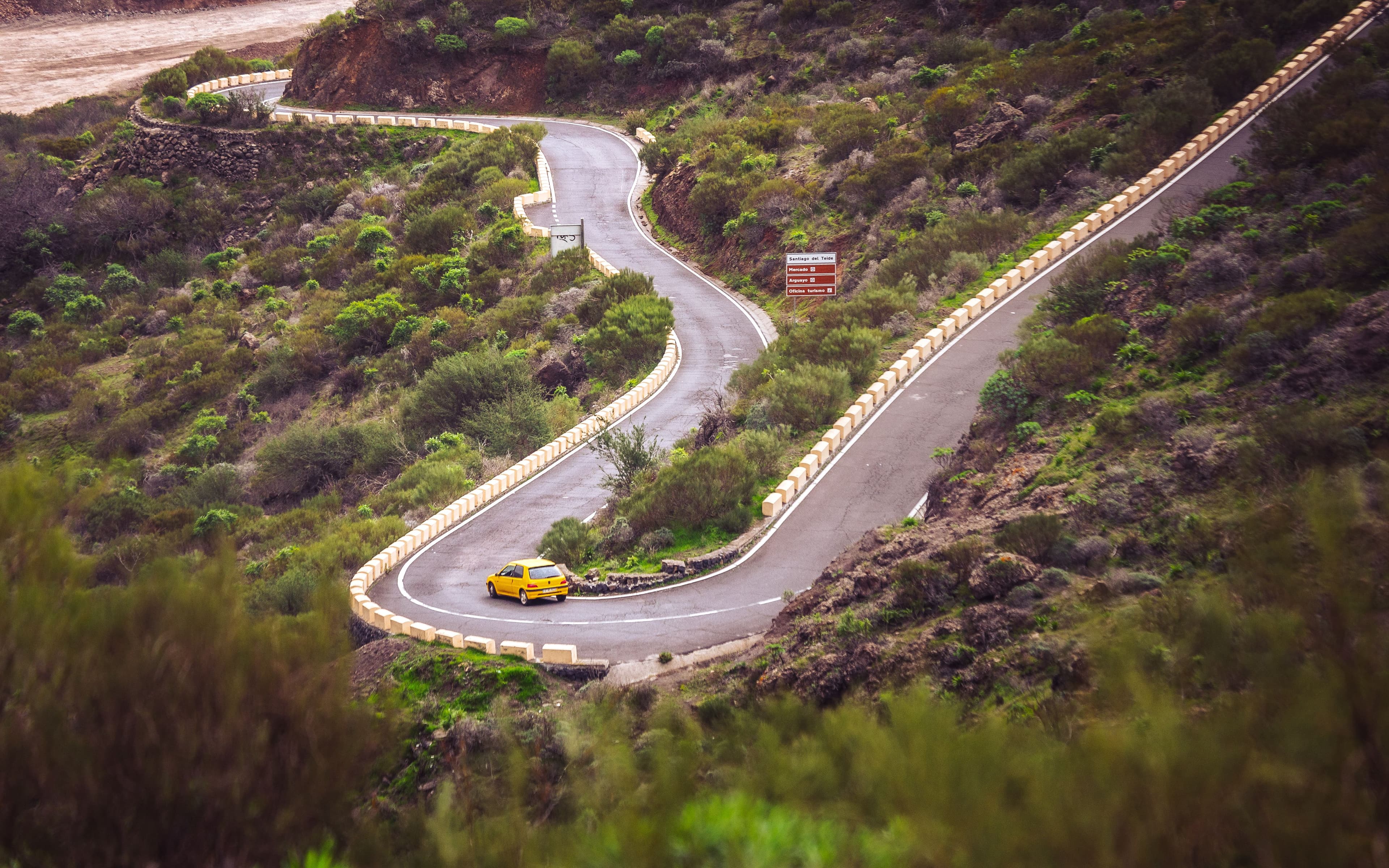 A car on a hairpin bend climbing a Canary Islands mountain road