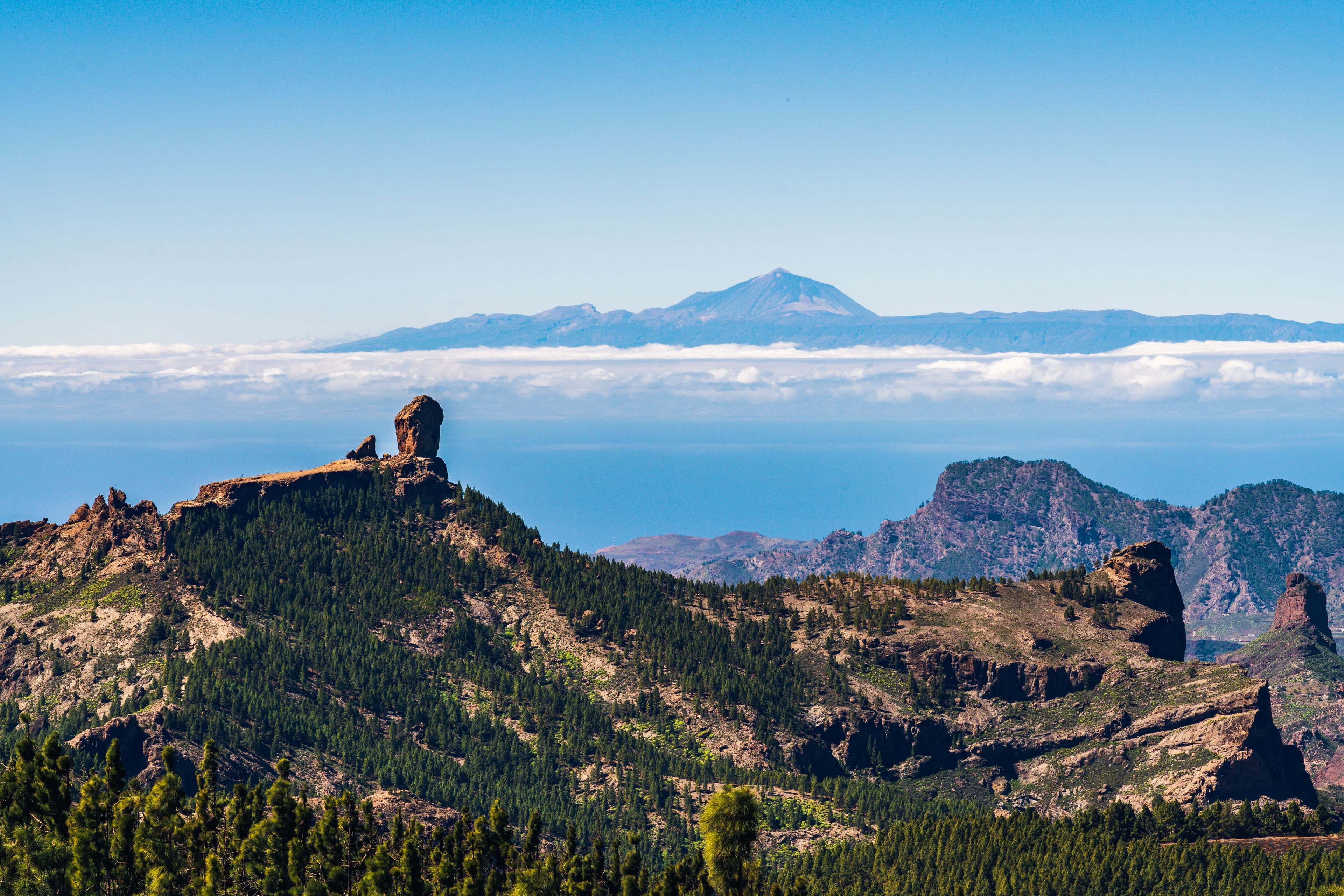 Roque Nublo with Teide visible across the sea beyond